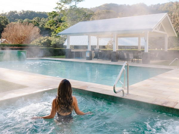 a woman dipping in the warm pool at Eden Health Retreat