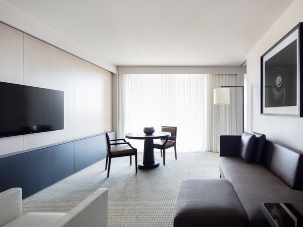 a lounge room with balcony in the Realm Suite, Hotel Realm Canberra