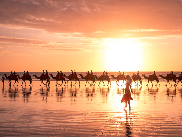 a group riding a camel at sunset, Cable Beach, Broome