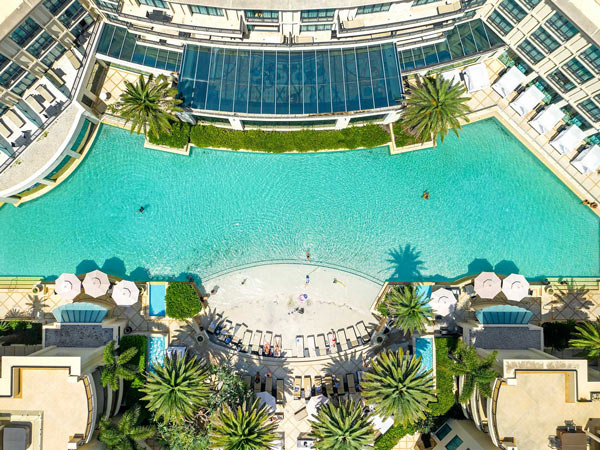 a drone shot of the crystal-blue lagoon pool at Palazzo Versace