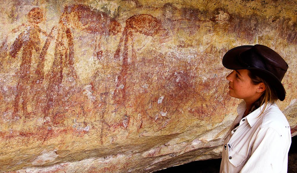 Davidson’s Arnhem Land Safari’s senior guide Clare Wallwork surveys figures in headdresses.