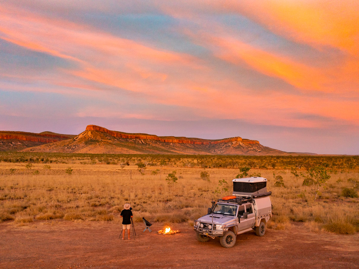 a man standing with a bonfire setup at sunset, the Kimberly and Gibb River Road trip