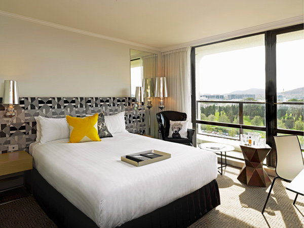 a room at QT Hotel Canberra with balcony