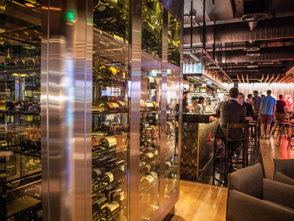 a floor-to-ceiling wine fridge in QT Canberra wine cellar