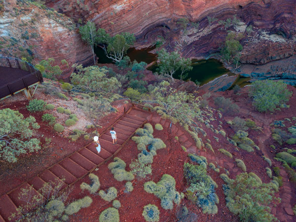 an aerial view of two people exploring Hamersley Gorge