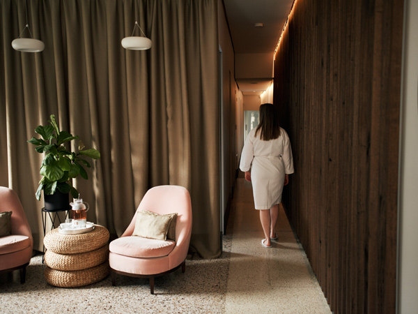 a woman in robe walking into Blanc Spa, Prahran