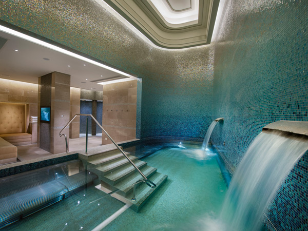 an indoor pool with mini waterfalls at Crown Spa at Crown Towers, Southbank