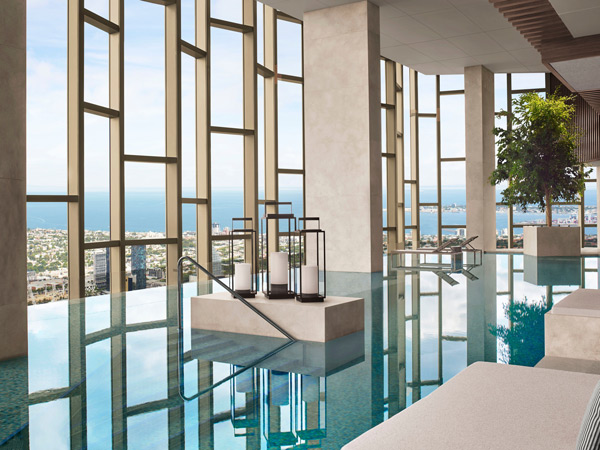 an indoor pool with floor-to-ceiling windows at The Ritz-Carlton Spa, CBD