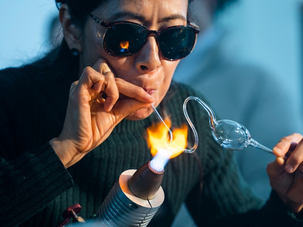 a glass artist playing with flame