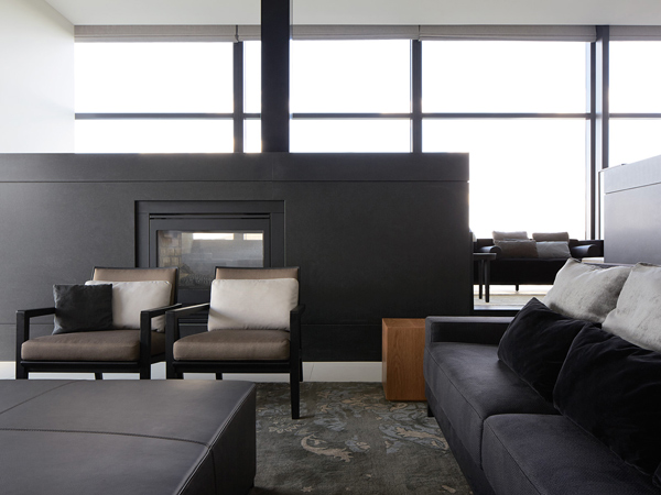 a black sofa set inside Little National Hotel, Canberra