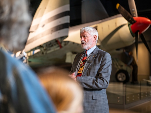 a war veteran speaking in front of visitors