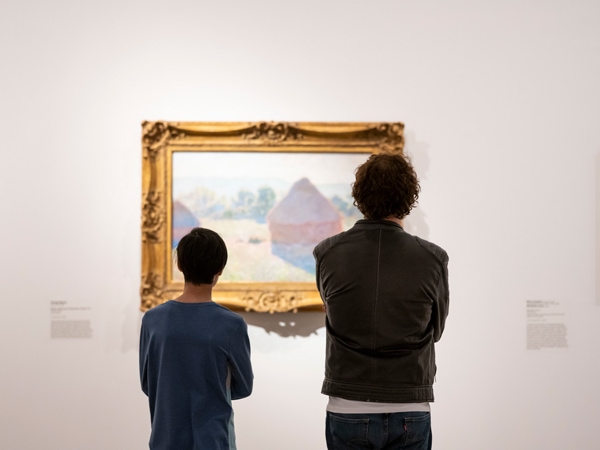 a father and son looking at an art display inside National Gallery of Australia