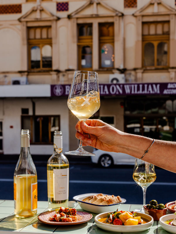 a hand raising a glass at No Mafia, Perth