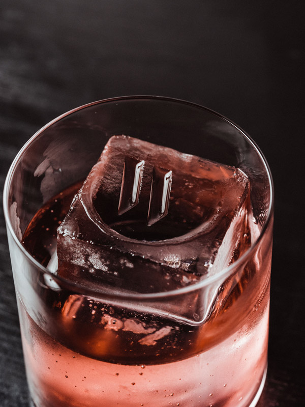 a cocktail with hand-carved artisanal ice