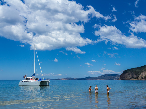 a group of people with a boat moored at Taroona Beach, Tas