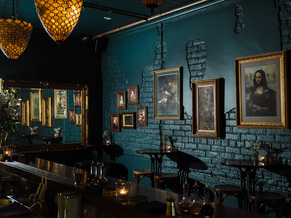 vintage art paintings on the walls at Bar Lafayette