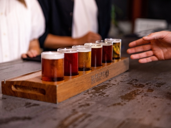 a hand reaching for craft beers lined on the table, Gold Coast