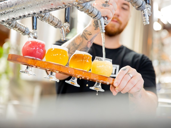 a bartender preparing a Precinct Beer Paddle, Gold Coast