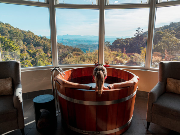 a girl soaking in the giant. tub at O'Reilly's Lost World Spa
