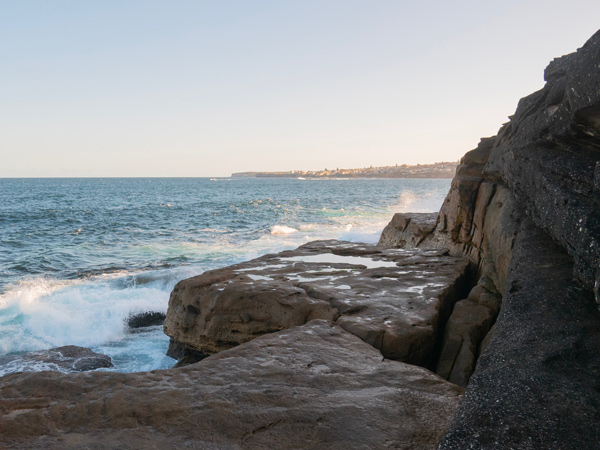 waves crashing to rocky ridges on Clovelly Beach