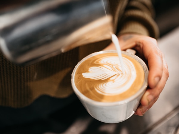 a bartender pouring coffee into a cup at Elk Espresso, Broadbeach