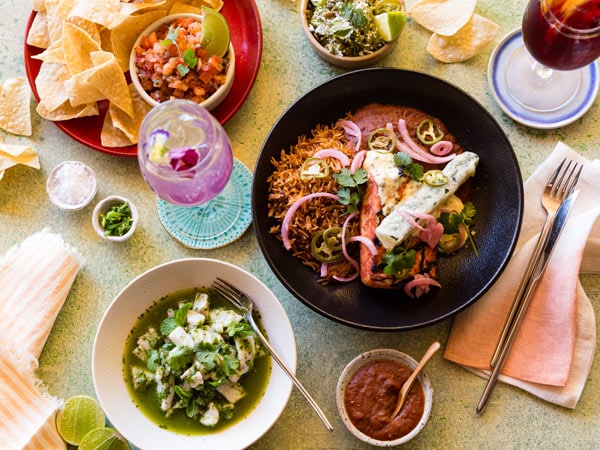 a table top view of Mexican dishes at Hot Tamale