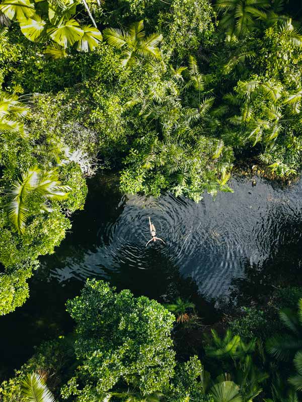 Aerial shot of someone swimming in Mason's Swimming hOle. (Image: Tourism Tropical North Queensland)