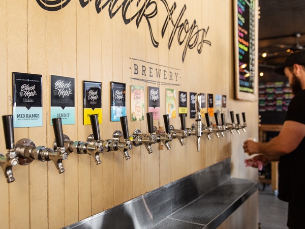 a guy getting beer on tap at Black Hops Brewery, Burleigh Heads Queensland