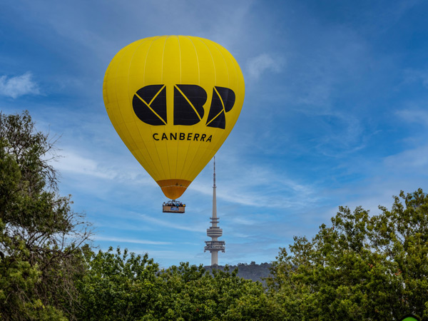 a hot-air balloon drifting over Canberra