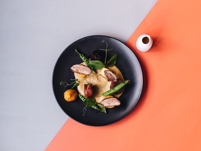 Neatly presented dish from Birch Restaurant in Moss Vale with orange and grey background