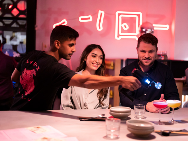 a restaurant staff serving cocktails for guests at Lazy Su, Braddon