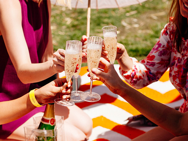 Women cheers drinks at So Frenchy So Chic in Melbourne.