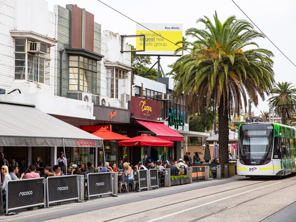 tram passes cafes and diners on Acland Street, St Kilda