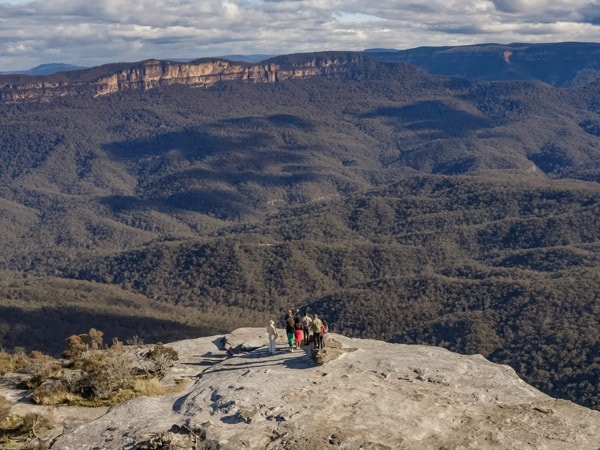 an overhead shot of people standing on the edge of Lincoln's Rock , Blue Mountains