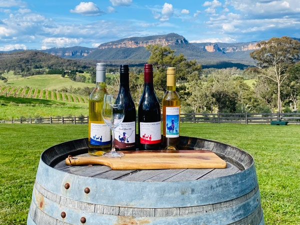bottles of wine on a barrel at Megalong Creek Estate