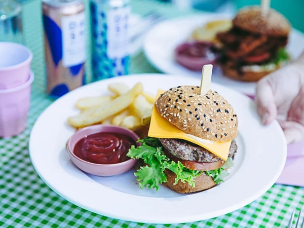 burger and fries with ketchup on the plate at The Wayzgoose Diner