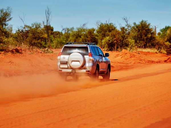 a 4WD vehicle driving along the red dirt in Cape Leveque