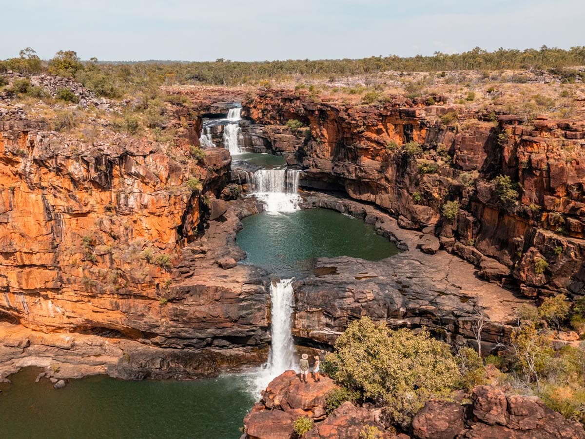 Two people standing at Mitchell Falls in the Kimberley (Image: Tourism Australia)