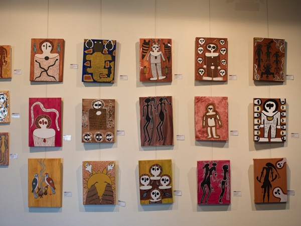 paintings displayed on the wall at Mowanjum Art and Culture Centre