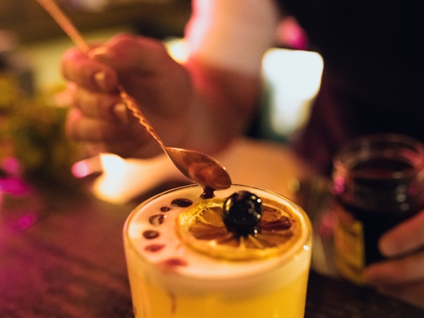 a bartender creating a whisky cocktail at The Doss House, The Rocks