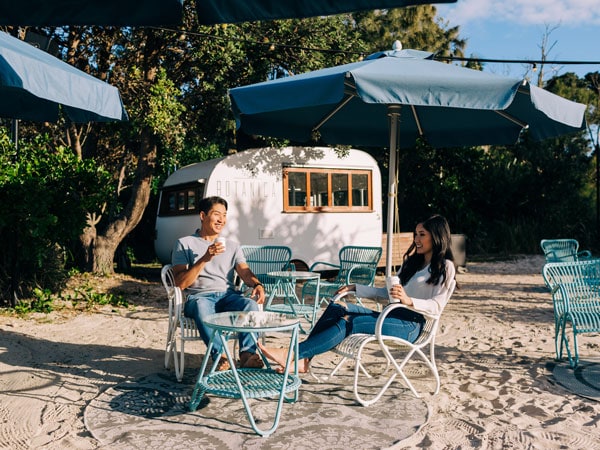 a couple relaxing at the Botanica Beach Club, Elements of Byron