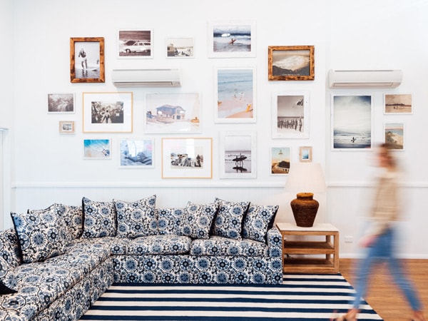 a woman stepping inside the living room at The Surf House, Byron Bay