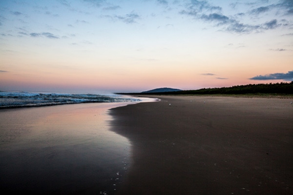 Sunset over beach and ocean