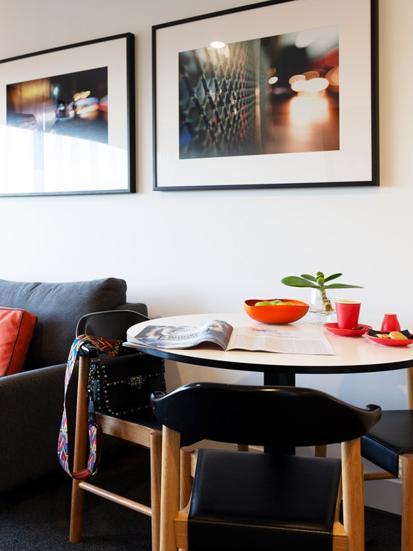 a dining table with chairs at East Hotel Canberra