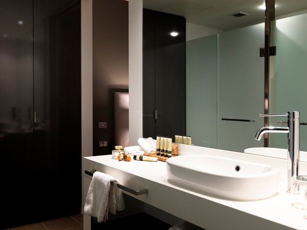 the bathroom inside one of the rooms at East Hotel Canberra