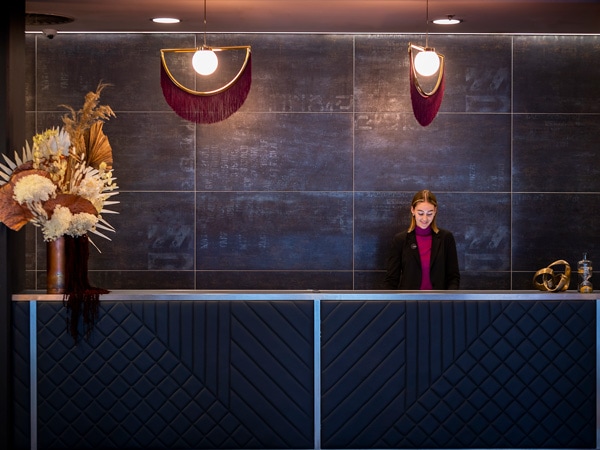 a receptionist at the lobby of East Hotel Canberra