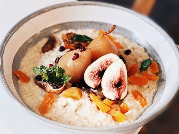 a bowl of poached pear porridge at Lokal + Co, Brisbane