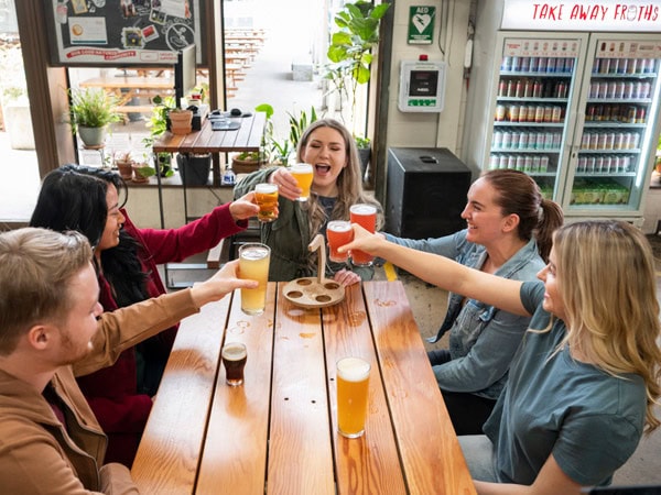 friends raising their beer glasses at Capital Brewing Co., Fyshwick