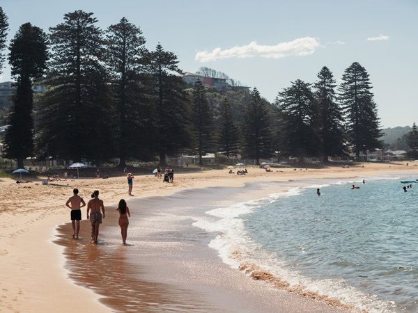 Visitors enjoying a day at Avoca Beach on the Central Coast.