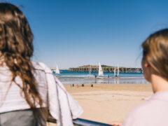 two women standing on jetty beach coffs harbour